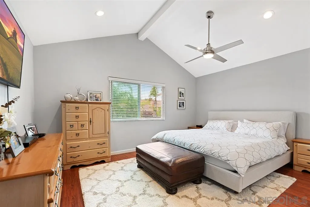 5673 Raintree Way Oceanside, CA 92057 - Photo 10 of 23 a bedroom with a bed a dresser and a chandelier