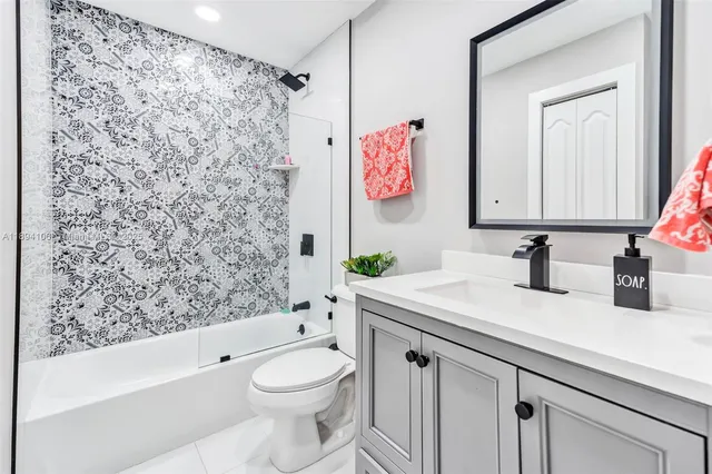 a bathroom with a sink a toilet and a shower curtain
