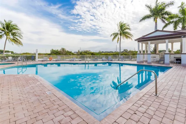 a view of a swimming pool with a table and chairs