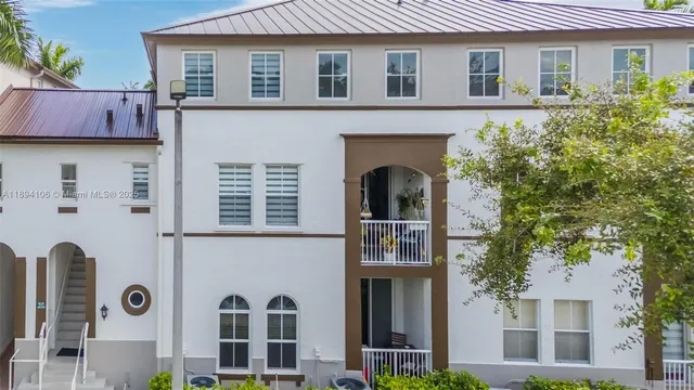 a front view of a house with plants