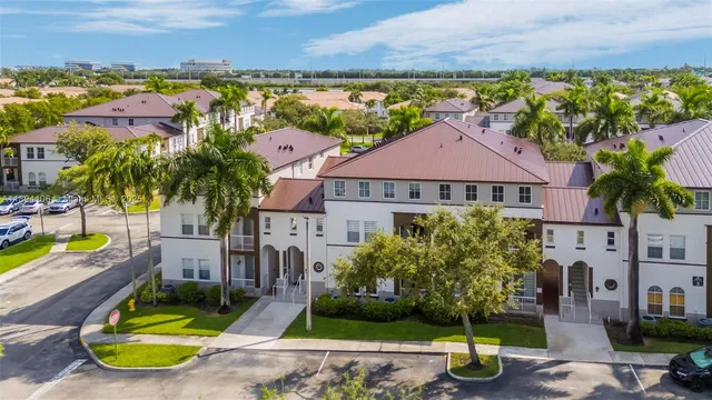 an aerial view of residential houses with yard and swimming pool