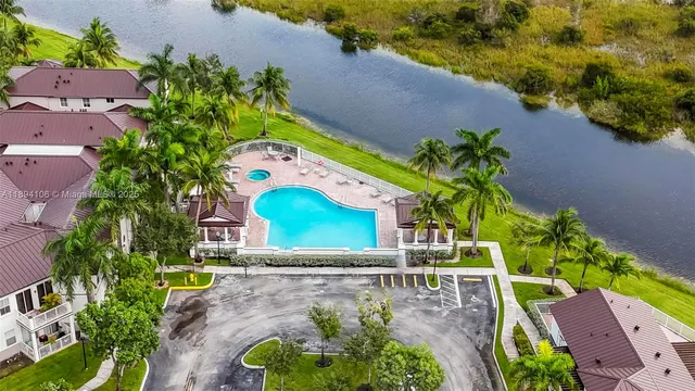 an aerial view of a house with a yard and a fountain