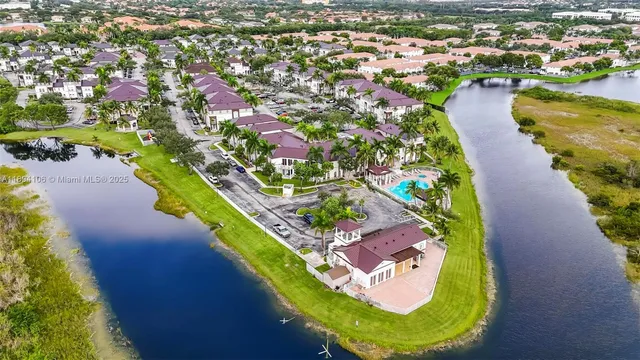 an aerial view of a house with a swimming pool yard and lake view