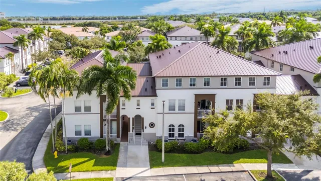 a aerial view of a house with a yard and potted plants