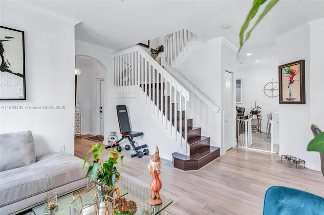a living room with furniture and a wooden floor