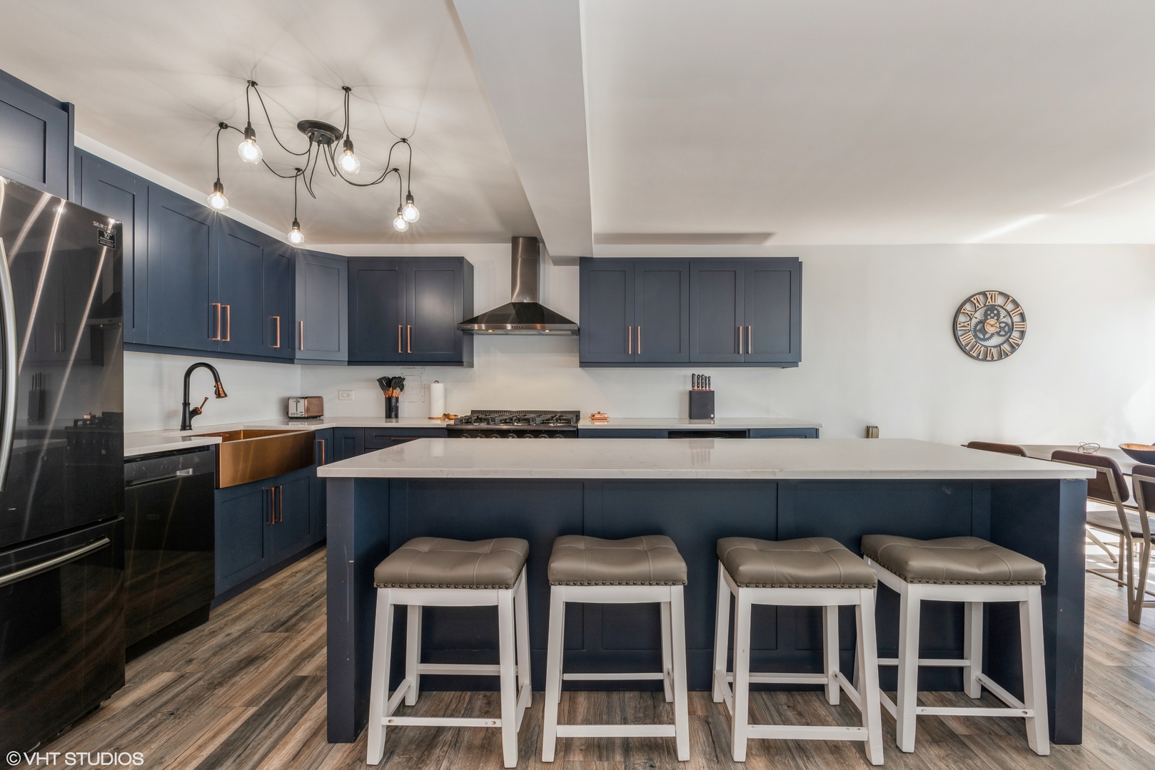 5801 North Sheridan Road, Unit 16E Chicago, IL 60660 - Photo 2 of 12 a kitchen with granite countertop a table chairs stainless steel appliances and cabinets