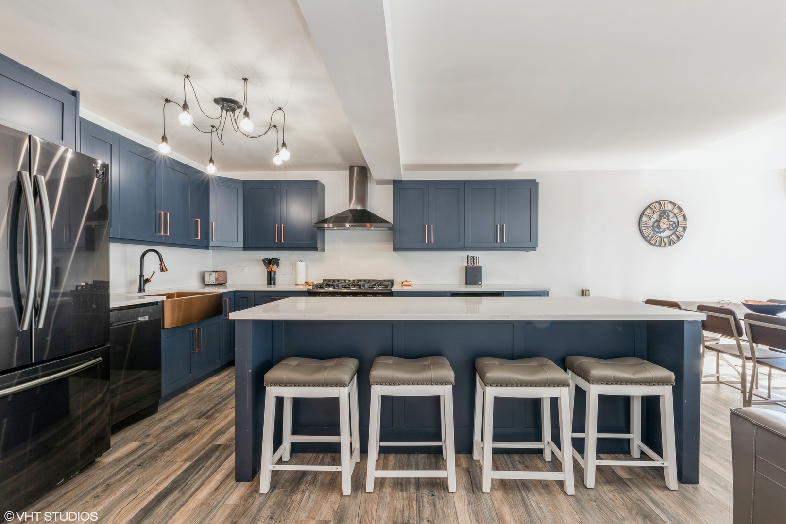 5801 North Sheridan Road, Unit 16E Chicago, IL 60660 - Photo 3 of 12 a kitchen with granite countertop a table chairs stainless steel appliances and cabinets