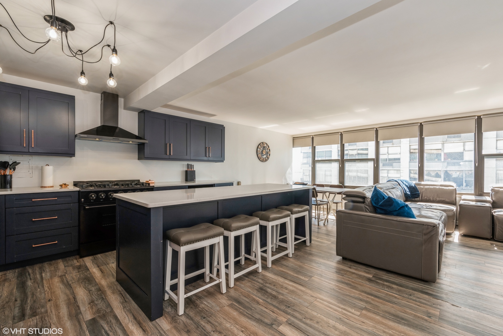 5801 North Sheridan Road, Unit 16E Chicago, IL 60660 - Photo 4 of 12 a kitchen with stainless steel appliances granite countertop a stove and a view of living room