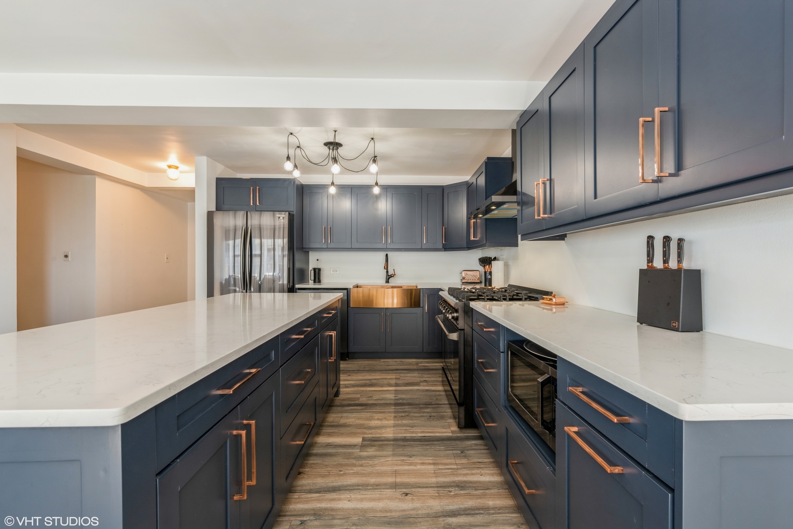 5801 North Sheridan Road, Unit 16E Chicago, IL 60660 - Photo 5 of 12 a kitchen with kitchen island stainless steel appliances a sink stove top oven and cabinets