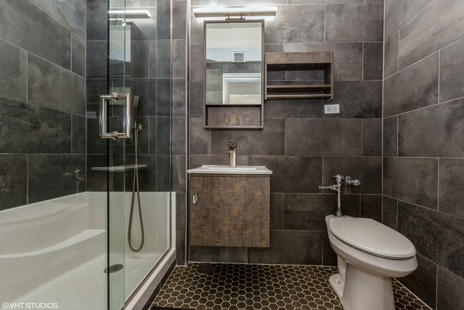 5801 North Sheridan Road, Unit 16E Chicago, IL 60660 - Photo 9 of 12 a bathroom with a sink a toilet and shower