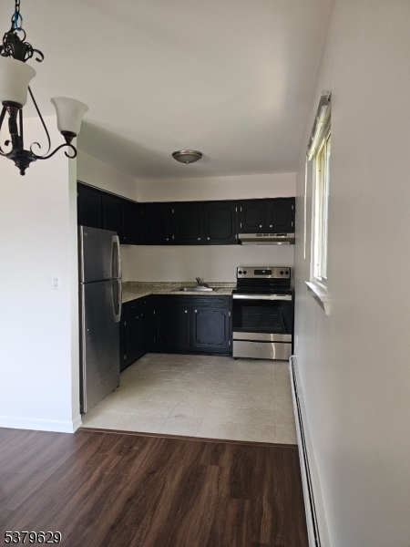 156 Highway 46, Unit 22 Rockaway, NJ 07866 - Photo 6 of 10 a kitchen with granite countertop a refrigerator and a stove