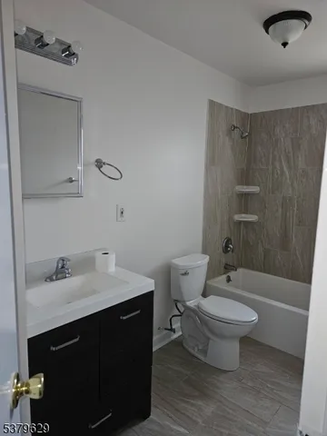 a bathroom with a sink toilet a mirror and shower