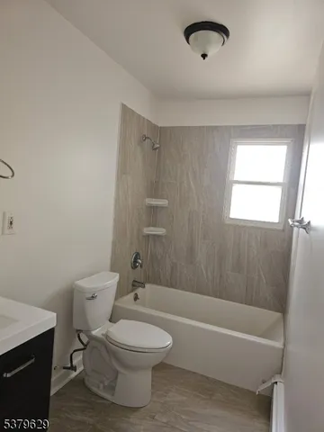 a bathroom with a toilet a sink and bathtub