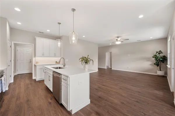 a kitchen with a stove a sink and a refrigerator