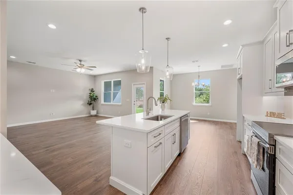 a kitchen with kitchen island a sink stainless steel appliances and cabinets