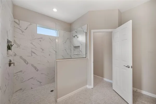 a bathroom with a shower and a sink