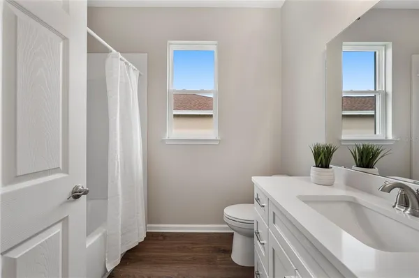 a bathroom with a sink toilet and vanity