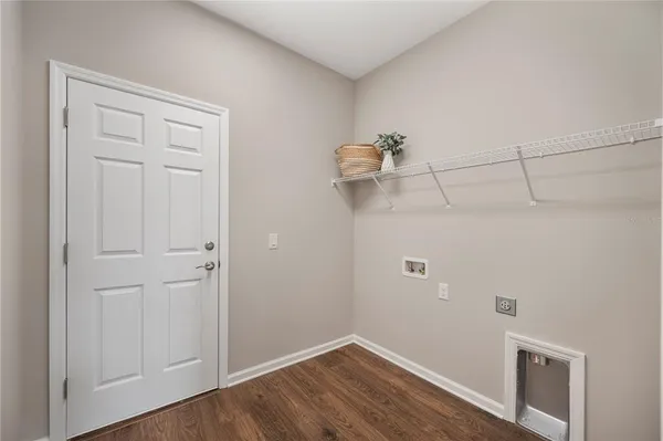 a view of a room with wooden floor