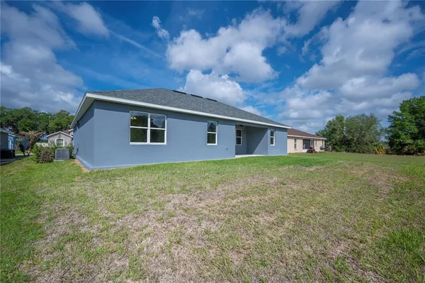 a front view of house with yard and trees