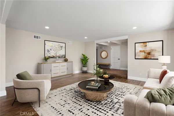 a living room with furniture a chandelier and a table