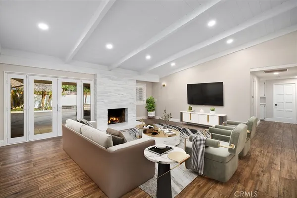 a spacious bedroom with a bed and a flat screen television