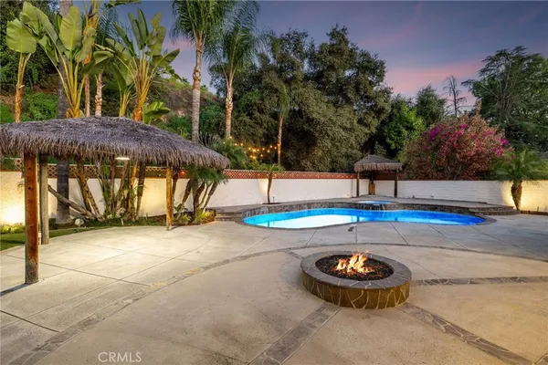 a view of a house with a backyard