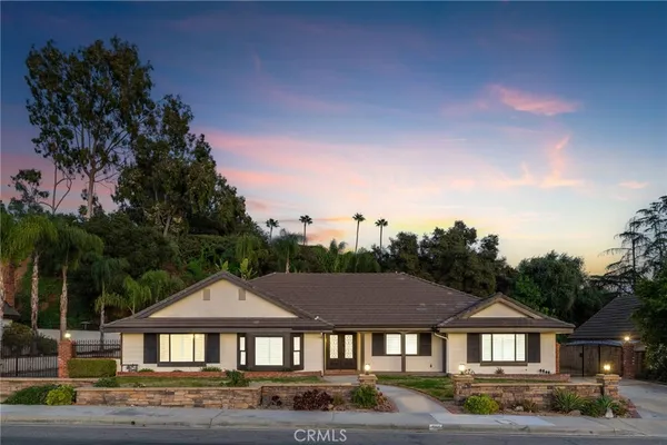 a front view of a house with a yard outdoor seating and barbeque oven