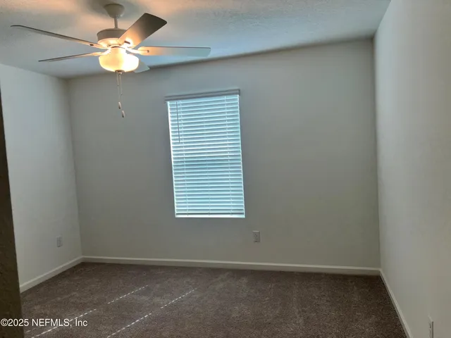 a bedroom with a bed and a lamp