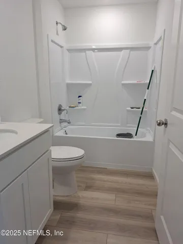 a view of bathroom with a sink and mirror