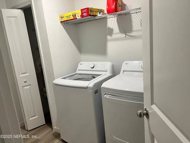 a kitchen with stainless steel appliances a stove a sink a refrigerator a microwave a sink and cabinets