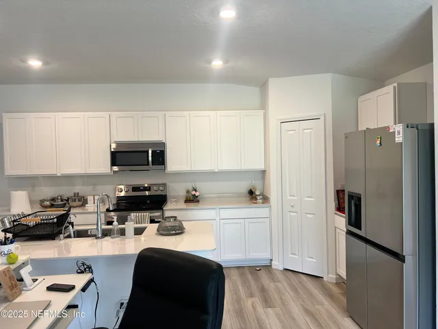 a bathroom with a sink mirror vanity and toilet