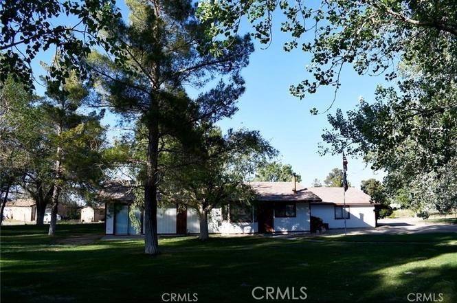 10831 Monte Vista Road Phelan, CA 92371 - Photo 3 of 13 a front view of a house with a garden