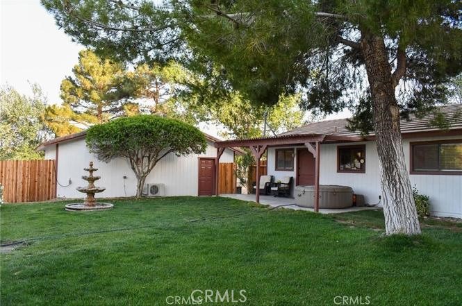 10831 Monte Vista Road Phelan, CA 92371 - Photo 9 of 13 a front view of a house with a garden and yard