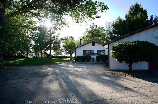10831 Monte Vista Road Phelan, CA 92371 - Photo 10 of 13 a front view of a house with a yard and trees