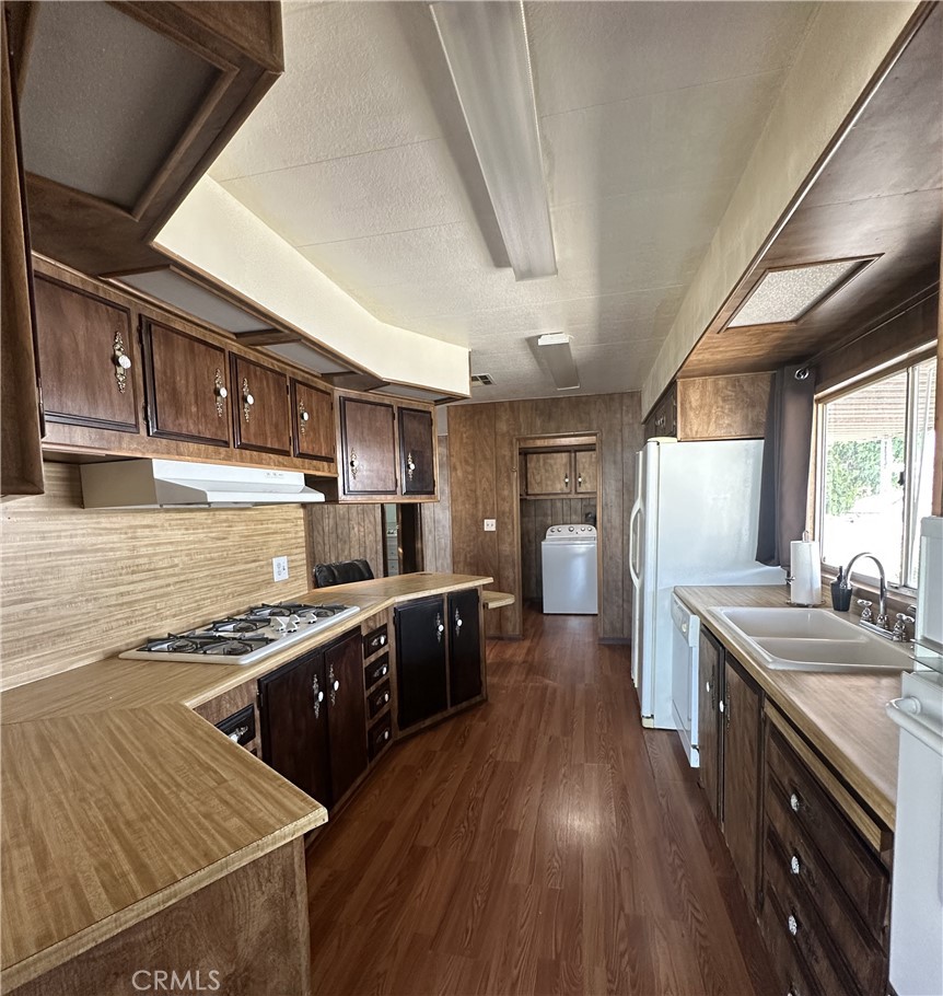 950 California Street, Unit 60 Calimesa, CA 92320 - Photo 8 of 26 a kitchen with stainless steel appliances granite countertop a sink stove and refrigerator