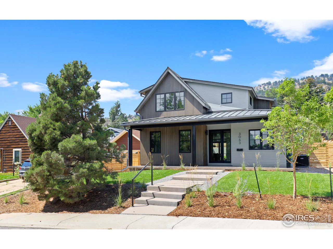 3063 7th Street Boulder, CO 80304 - Photo 1 of 39 a front view of a house with a garden