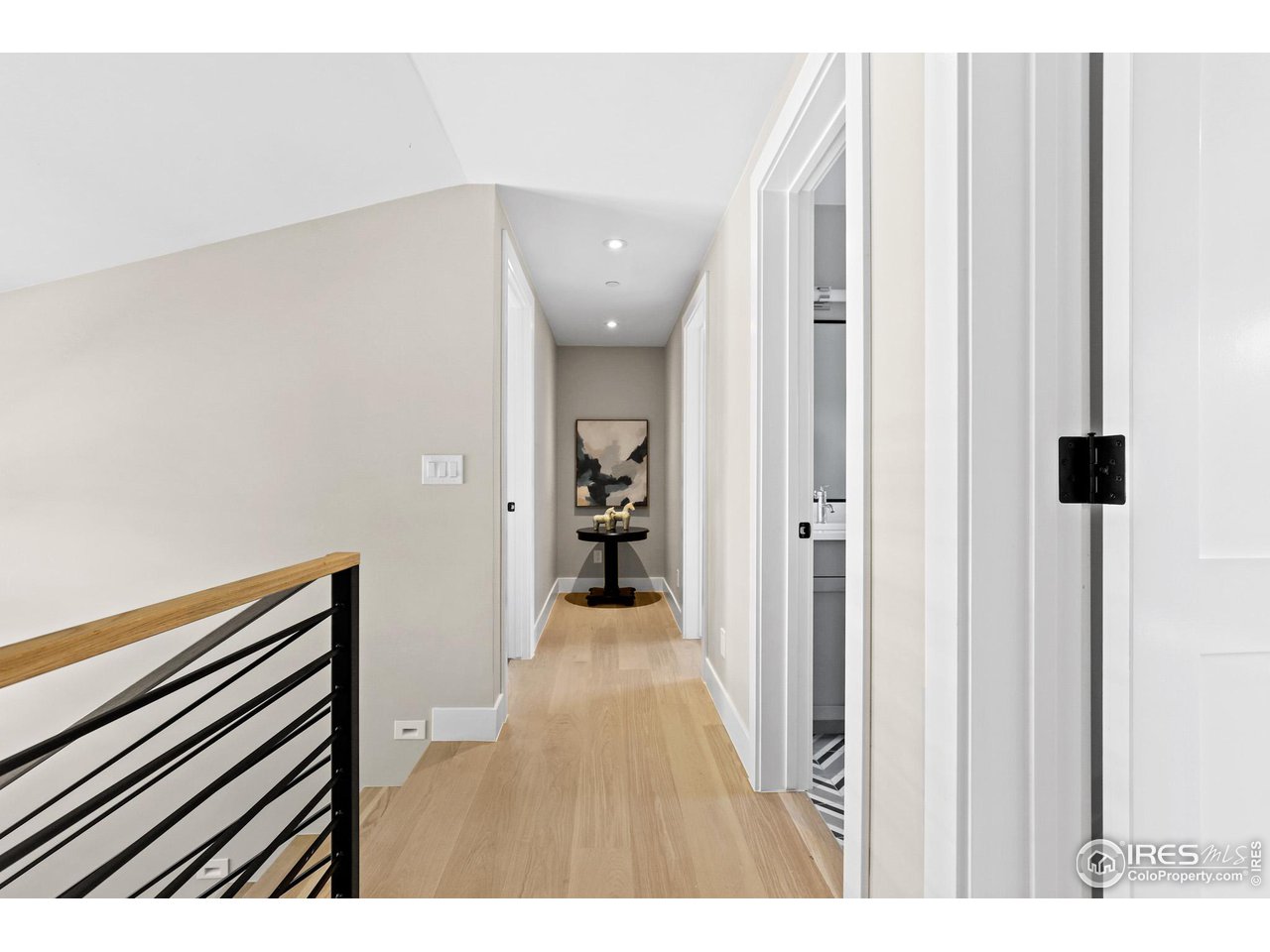 3063 7th Street Boulder, CO 80304 - Photo 16 of 39 a view of a hallway with wooden floor and staircase