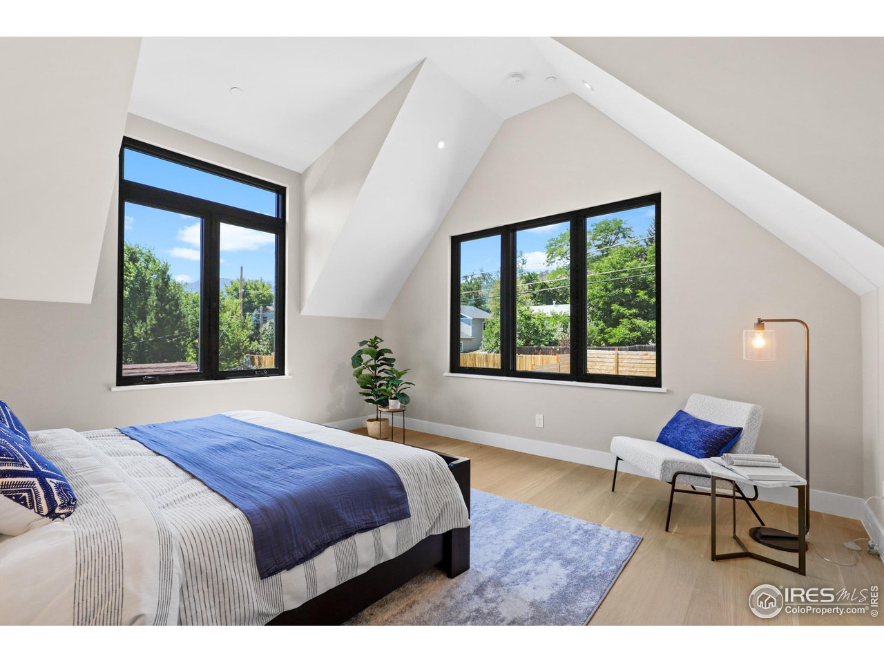 3063 7th Street Boulder, CO 80304 - Photo 17 of 39 a bed sitting in a bedroom next to a window