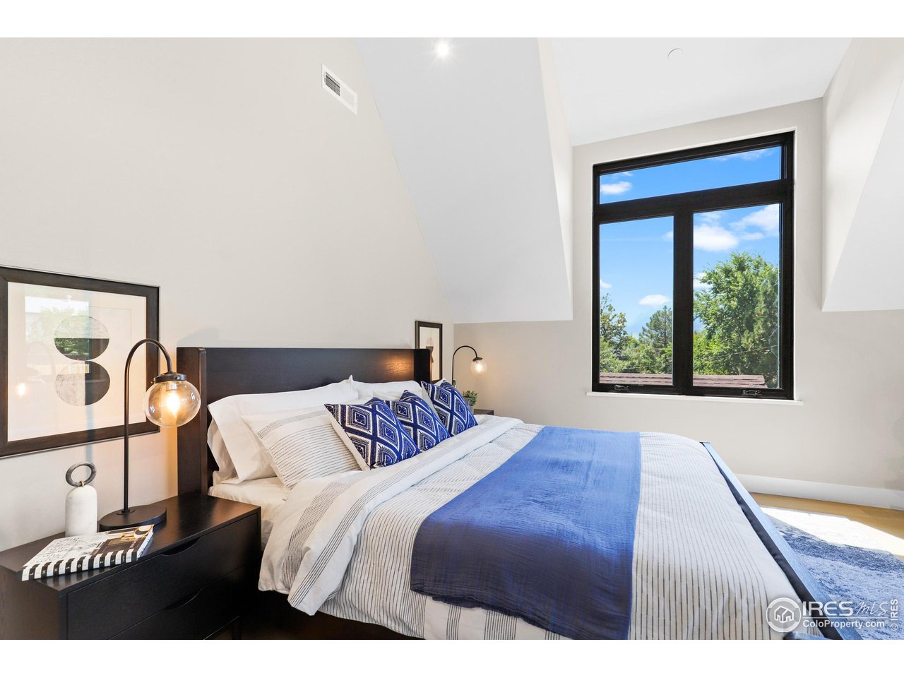 3063 7th Street Boulder, CO 80304 - Photo 19 of 39 a bedroom with a bed and a window