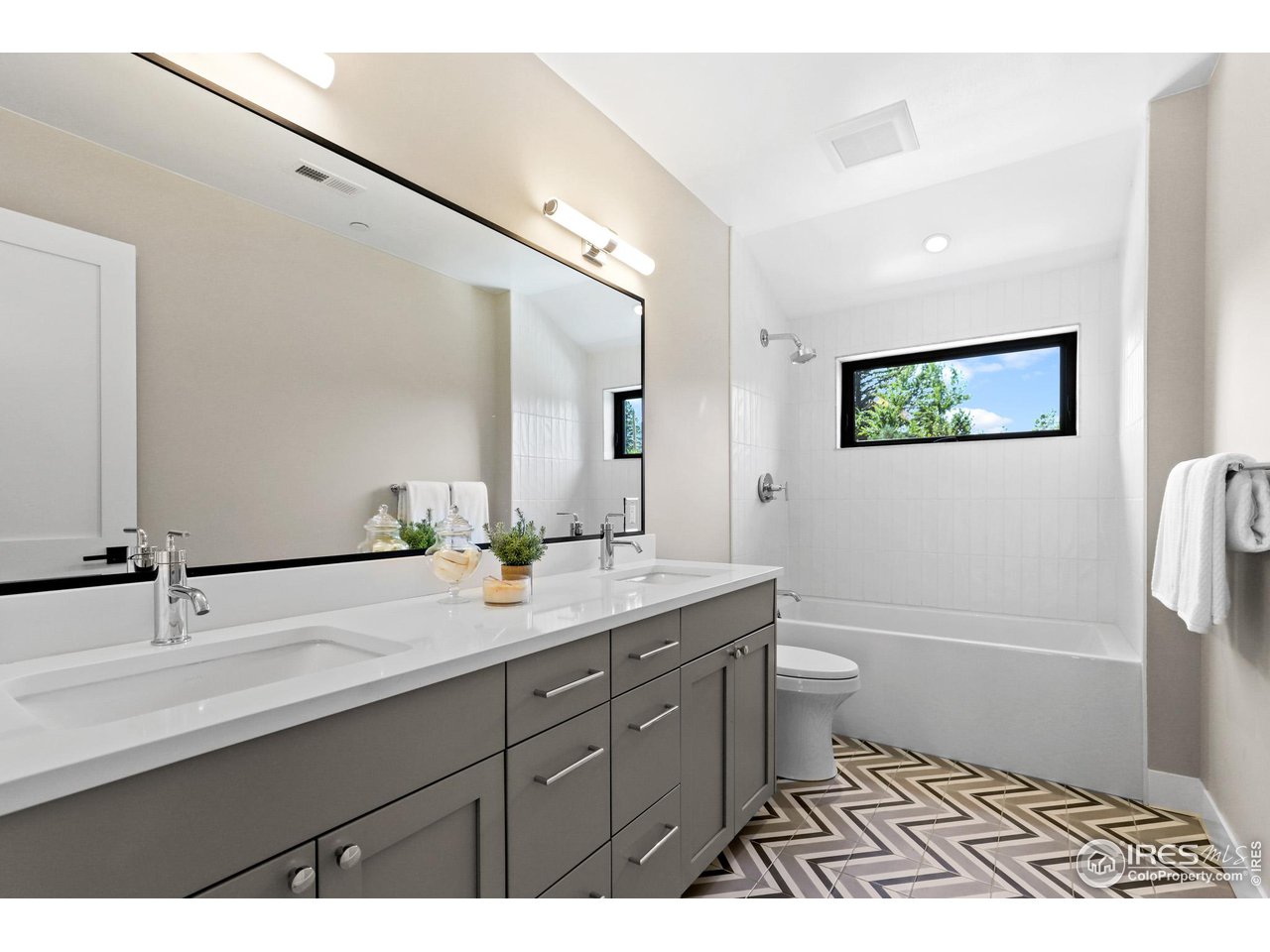 3063 7th Street Boulder, CO 80304 - Photo 23 of 39 a bathroom with a double vanity sink a toilet and a mirror