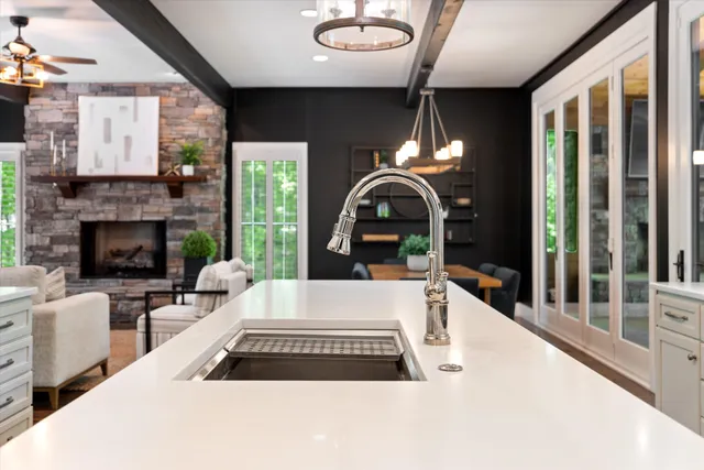 a kitchen with stainless steel appliances granite countertop a sink a stove and a refrigerator