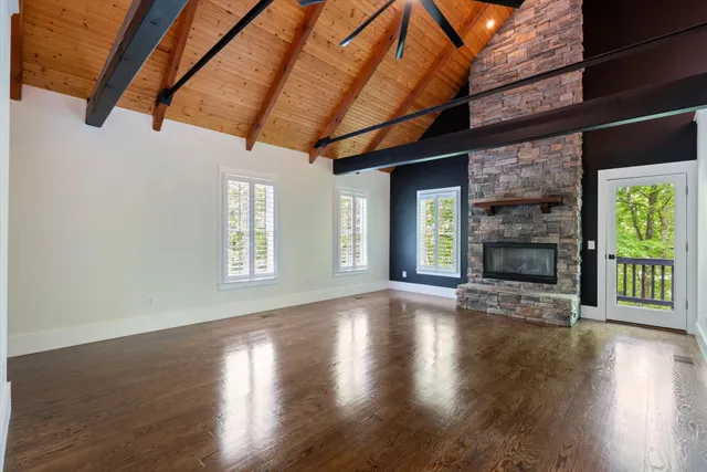 a living room with a fireplace and a floor to ceiling window
