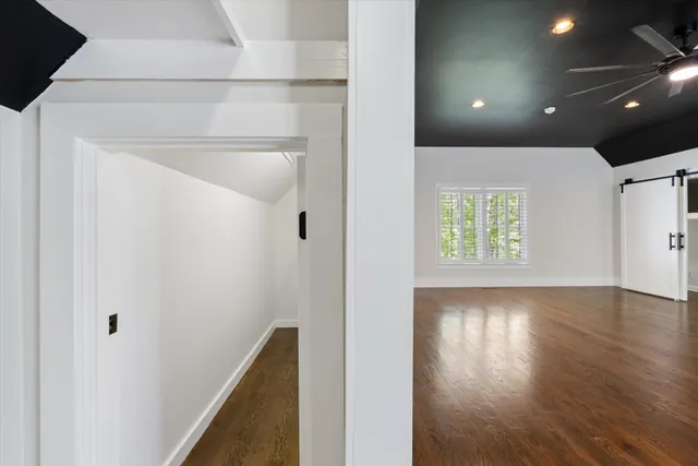 a view of empty room with wooden floor