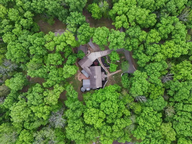 an aerial view of a house with a yard