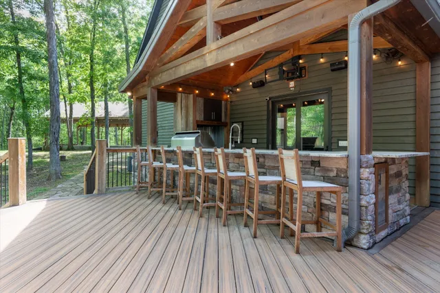 a view of a porch with furniture and a backyard