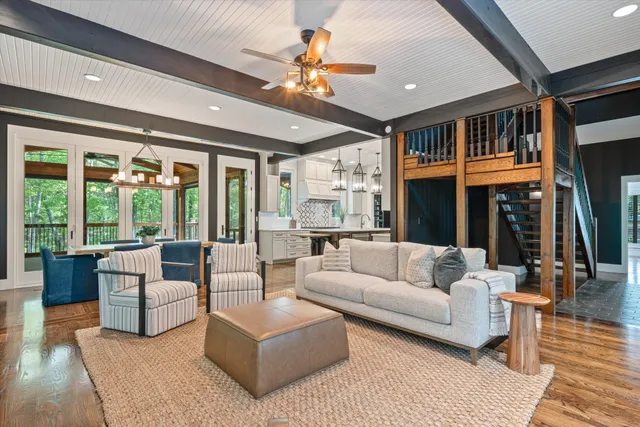 a living room with furniture ceiling fan and a rug