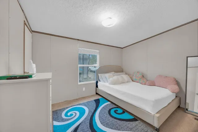 a bedroom with a bed and a window