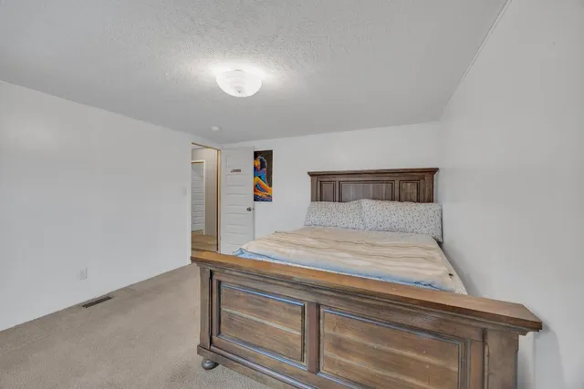 a bedroom with a bed and window