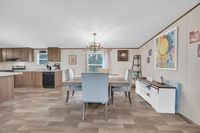 a living room with granite countertop furniture a dining table and kitchen view