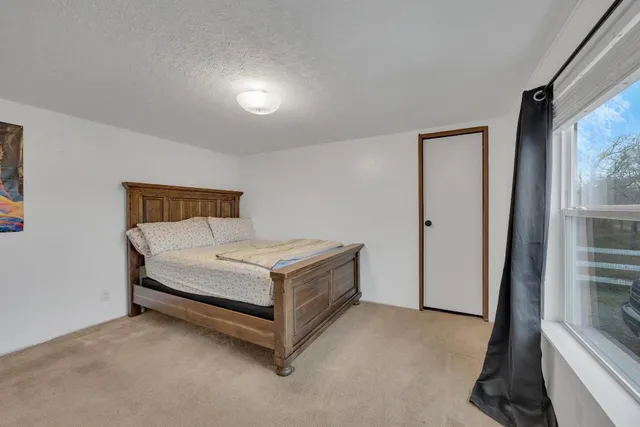 a room with a bed and a mirror